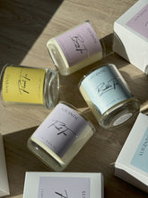 Load image into Gallery viewer, 4 candles in glass containers lying flat.