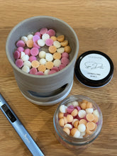 Load image into Gallery viewer, Colorful candies in a small container on a wooden surface with an electric lighter and another container in the background.