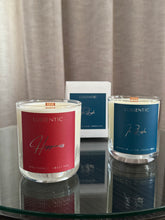 Load image into Gallery viewer, Two Luscentic candles on a reflective surface with neutral curtains in the background