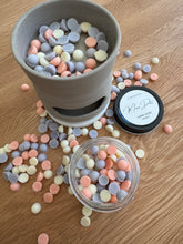 Load image into Gallery viewer, Colorful round candies in a gray pot and small container on a wooden surface.