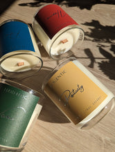 Load image into Gallery viewer, Colourful labels of candles in glass containers.