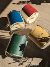 Load image into Gallery viewer, 4 wooden wick candles laying down with the tops facing towards the middle. The blue candle is in the top left, red candle is in the top right, green candle is on the bottom left and yellow candle is on the bottom right.