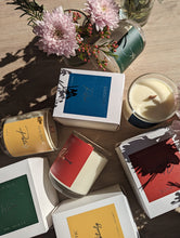 Load image into Gallery viewer, Colourful candles surrounded by flowers and candle boxes.