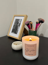 Load image into Gallery viewer, Luscentic candle on a table with makeup brushes and a photo frame in the background
